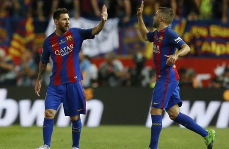 Barcelona's Lionel Messi, left, is congratulated by Barcelona's Jordi Alba after he scored the opening goal during the Copa del Rey final soccer match between Barcelona and Alaves at the Vicente Calderon stadium in Madrid, Spain, Saturday, May 27, 2017. (AP Photo/Francisco Seco)
