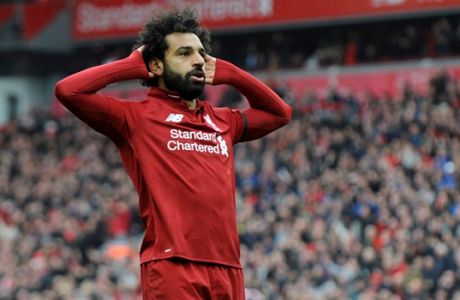 Liverpool's Mohamed Salah celebrates after scoring his side's second goal during the English Premier League soccer match between Liverpool and Chelsea at Anfield stadium in Liverpool, England, Sunday, April 14, 2019. (AP Photo/Rui Vieira)