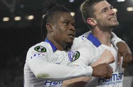 Gent's Hugo Cuyper, right, celebrates Gent's Gift Emmanuel Orban after scoring his side's opening goal during the Conference League soccer match between West Ham and Gent at the London stadium in London, England, Thursday, April 20, 2023. (AP Photo/Kin Cheung)