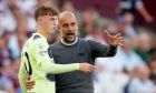 Manchester City's head coach Pep Guardiola instructs Manchester City's Cole Palmer during their English Premier League soccer match between West Ham United and Manchester City at the London Stadium in London, England, Sunday, Aug. 7, 2022. (AP Photo/Frank Augstein)