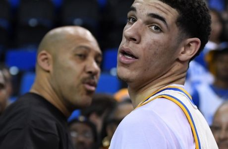 UCLA guard Lonzo Ball, right, walks away after hugging his father, LaVar, following the team's NCAA college basketball game against Washington State, Saturday, March 4, 2017, in Los Angeles. UCLA won 77-68. (AP Photo/Mark J. Terrill)