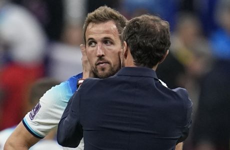 England's Harry Kane is comforted by head coach Gareth Southgate after losing 1-2 against France during the World Cup quarterfinal soccer match between England and France, at the Al Bayt Stadium in Al Khor, Qatar, Sunday, Dec. 11, 2022. (AP Photo/Abbie Parr)