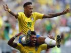 Brazil's Neymar, top, celebrates with team mate Paulinho after scoring his side's opening goal during the round of 16 match between Brazil and Mexico at the 2018 soccer World Cup in the Samara Arena, in Samara, Russia, Monday, July 2, 2018. (AP Photo/Frank Augstein)