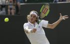 Stefanos Tsitsipas of Greece returns a ball to John Isner of the US during their men's singles match on the seventh day at the Wimbledon Tennis Championships in London, Monday July 9, 2018. (AP Photo/Ben Curtis)