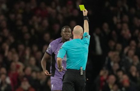 Liverpool's Ibrahima Konate, left, receives a yellow card from referee Anthony Taylor during the English Premier League soccer match between Arsenal and Liverpool at Emirates Stadium in London,, Sunday, Feb. 4, 2024. (AP Photo/Kin Cheung)