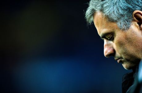 Real Madrid's coach Jose Mourinho from Portugal reacts during his team's 5-0 loss against FC Barcelona during a Spanish La Liga soccer match at the Camp Nou stadium in Barcelona, Spain, Monday, Nov. 29, 2010. (AP Photo/Manu Fernandez)