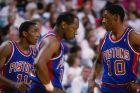 1988:  Guard Isiah Thomas, left, forward Dennis Rodman, right, and forward Vinnie Johnson of the Detroit Pistons talk to each other during a game. Mandatory Credit: Allsport  /Allsport