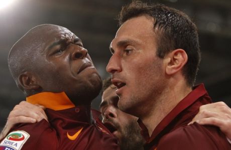 Romas Vasileios Torosidis, right, celebrates with teammates Victor Ibarbo, left, and Miralem Pjanic after scoring during a Serie A soccer match between Roma and Udinese, at Rome's Olympic stadium, Sunday, May 17, 2015. (AP Photo/Riccardo De Luca)