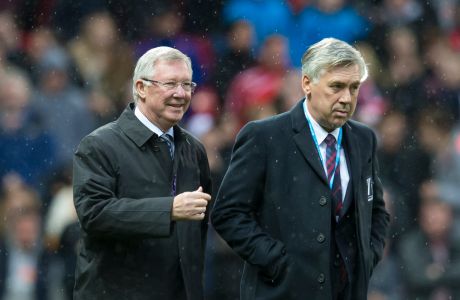 Great Britain and Ireland's manager Sir Alex Ferguson takes to the touchline alongside The Rest of the World's manager Carlo Ancelotti before the Unicef Match for Children charity football match between a Great Britain and Ireland team and a Rest of the World team at Old Trafford Stadium, Manchester, England, Saturday, Nov. 14, 2015. (AP Photo/Jon Super)  