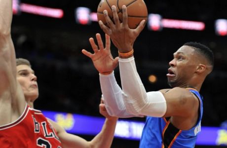 Oklahoma City Thunder's Russell Westbrook (0) goes up to shoot against Chicago Bulls' Lauri Markkanen (24), of Finland, during the second half of an NBA basketball game Saturday, Oct. 28, 2017, in Chicago. (AP Photo/Paul Beaty)