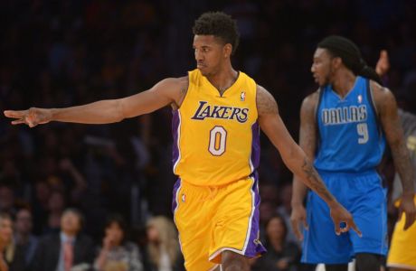 Apr 4, 2014; Los Angeles, CA, USA; Los Angeles Lakers guard Nick Young (0) reacts after a 3-point basket as Dallas Mavericks forward Jae Crowder (9) watches at Staples Center. Mandatory Credit: Kirby Lee-USA TODAY Sports