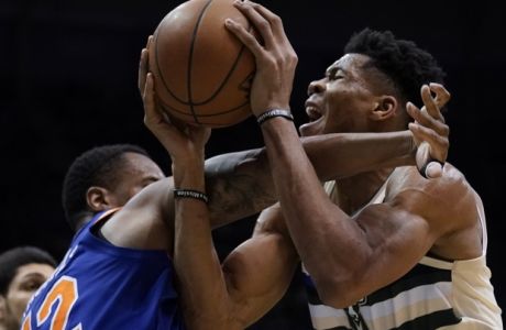 Milwaukee Bucks' Giannis Antetokounmpo is fouled by New York Knicks' Lance Thomas during the second half of an NBA basketball game Friday, March 9, 2018, in Milwaukee. The Bucks won 120-112. (AP Photo/Morry Gash)