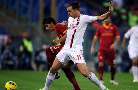AS Roma defender Jose Valdes Diaz (L) vies with AC Milan's Zlatan Ibrahimovic during their Serie A football match at Rome's Olympic Stadium on October 29, 2011 . AFP PHOTO / Filippo MONTEFORTE (Photo credit should read FILIPPO MONTEFORTE/AFP/Getty Images)