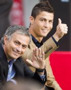 Real Madrid's head coach Jose Mourinho from Portugal, waves, while Real Madrid player Cristiano Ronaldo from Portugal gives his thumb up during an award ceremony to the best soccer players, in Madrid, Monday, Oct. 3, 2011. (AP Photo/Daniel Ochoa de Olza)