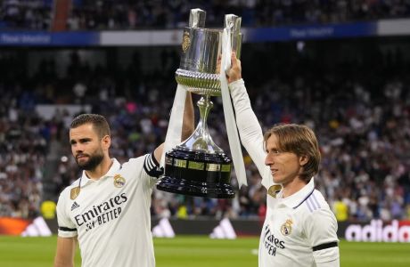 Real Madrid's Nacho, left, and Luka Modric hold up the Copa del Rey trophy prior to a Spanish La Liga soccer match between Real Madrid and Getafe at the Santiago Bernabeu stadium in Madrid, Spain, Saturday, May 13, 2023. (AP Photo/Manu Fernandez)