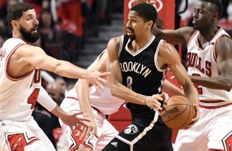 Brooklyn Nets guard Spencer Dinwiddie (8) is defended by Chicago Bulls forward Nikola Mirotic, left, and guard Jerian Grant, right, during the first half of an NBA basketball game in Chicago, Wednesday, April 12, 2017. (AP Photo/David Banks)