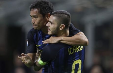 Inter Milan's Mauro Icardi, right, celebrates with his teammate Yuto Nagatomo after scoring his side's first goal during the Serie A soccer match between Inter Milan and Torino at the Milan San Siro stadium, Wednesday, Oct. 26, 2016. (AP Photo/Luca Bruno)