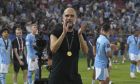 Manchester City's head coach Pep Guardiola celebrates with players after winning the UEFA Super Cup Final soccer match between Manchester City and Sevilla at Georgios Karaiskakis stadium in Piraeus port, near Athens, Greece, Wednesday, Aug. 16, 2023. (AP Photo/Petros Giannakouris)