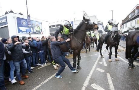 A mounted police officer talks to a soccer fan prior to the Tottenham Hotspur v Millwall, English FA Cup quarter final game at White Hart Lane, Tottenham, London Sunday March 12, 2017. (Yui Mok//PA via AP)