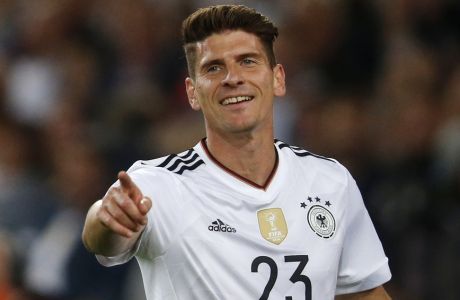 In this Monday, Sept. 4, 2017 photo Germany's Mario Gomez celebrates after scoring his side's sixth goal during the World Cup Group C qualifying soccer match between Germany and Norway in Stuttgart, Germany. Gomez leaves his current German first division, Bundesliga, club VfL Wolfsburg and signed a contract with his former club VfB Stuttgart with a contract duration until 2020. (AP Photo/Michael Probst)
