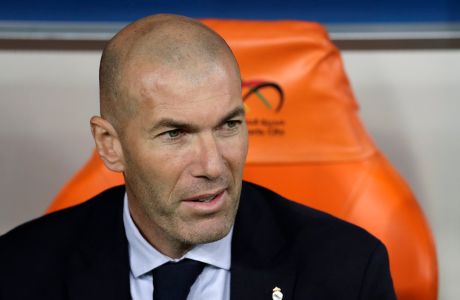 Real Madrid's head coach Zinedine Zidane sits on the bench during the Spanish Super Cup semifinal soccer match between Real Madrid and Valencia at King Abdullah stadium in Jiddah, Saudi Arabia, Wednesday, Jan. 8, 2020. (AP Photo/Hassan Ammar)
