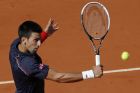 Serbia's Novak Djokovic returns the ball to Switzerland's Roger Federer  during their semifinal match in the French Open tennis tournament at the Roland Garros stadium in Paris, Friday, June 8, 2012. (AP Photo/Christophe Ena)