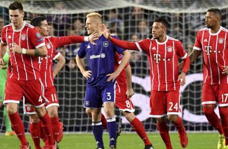 Bayern's James Rodriguez, center, left, shakes hands with teammate Bayern's Corentin Tolisso after Bayern scored their first goal during a Champions League Group B soccer match between Anderlecht and Bayern Munich at the Constant Vanden Stock stadium in Brussels, Belgium, Wednesday, Nov. 22, 2017. (AP Photo/Geert Vanden Wijngaert)