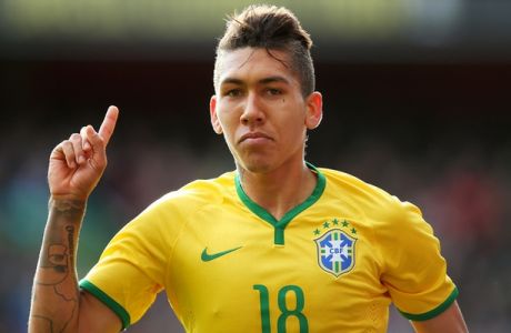 LONDON, ENGLAND - MARCH 29:  Firmino of Brazil celebrates after scoring the opening goal during the international friendly match between Brazil and Chile at the Emirates Stadium on March 29, 2015 in London, England.  (Photo by Paul Gilham/Getty Images)