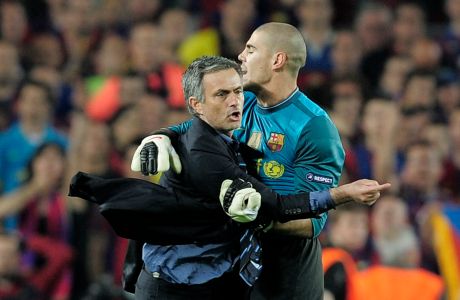 FC Barcelona's goalkeeper Victor Valdes, right, clashes with Inter Milan's coach Jose Mourinho from Portugal celebrating at the end of the Champions League semifinal second leg soccer match between FC Barcelona and Inter Milan at the Camp Nou stadium in Barcelona, Spain, Wednesday, April 28, 2010.  Inter lost the match 0-1, but went through to the final 3-2 on aggregate.  (AP Photo/David Ramos)
