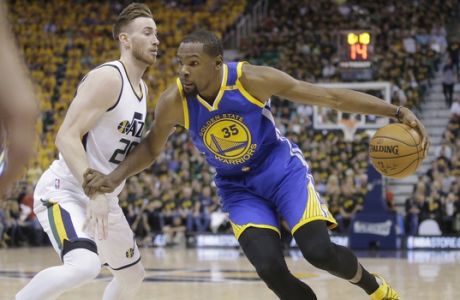 Utah Jazz forward Gordon Hayward (20) guards against Golden State Warriors forward Kevin Durant (35) who drives in the first half during Game 3 of the NBA basketball second-round playoff series Saturday, May 6, 2017, in Salt Lake City. (AP Photo/Rick Bowmer)
