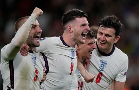 England players, from left, England's Luke Shaw, England's Declan Rice, England's Mason Mount and England's Harry Maguire, celebrate after winning during the Euro 2020 soccer championship semifinal match between England and Denmark at Wembley stadium in London, Wednesday,July 7, 2021. (AP Photo/Frank Augstein,Pool)
