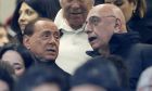 FILE - In this  Jan. 31, 2016 file photo, AC Milan president Silvio Berlusconi, left, is flanked by vice president Adriano Galliani during a Serie A soccer match between AC Milan and Inter Milan, at the San Siro stadium in Milan, Italy. The sale of AC Milan to a group of Chinese investors was again delayed on Friday, March 3, 2017. (AP Photo/Luca Bruno)