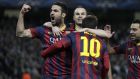 Barcelona's Lionel Messi, center, celebrates scoring the opening goal from a penalty with team mates Cesc Fabregas, left, and Andres Hiniesta during the Champions League first knock out round soccer match between Barcelona and Manchester City at the Etihad Stadium, Manchester, England, Tuesday Feb. 18, 2014. (AP Photo/Jon Super)  