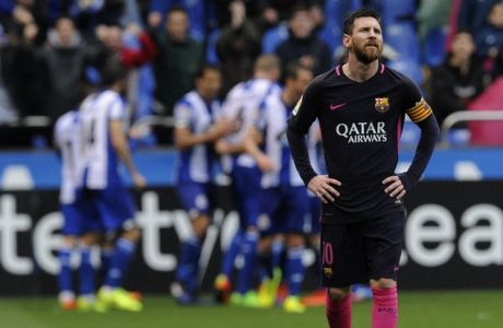 Barcelona's Lionel Messi reacts as Deportivo's players celebrate during a Spanish La Liga soccer match between Deportivo and Barcelona at the Riazor stadium in A Coruna, Spain, Sunday, March 12, 2017. (AP Photo/Paulo Duarte)