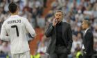 Real Madrid's coach Jose Mourinho from Portugal, center,  talks to Cristiano Ronaldo from Portugal, left, during their semifinal first leg Champions League soccer match against Barcelona at the Santiago Bernabeu stadium in Madrid, Wednesday, April 27, 2011. (AP Photo/Andres Kudacki)