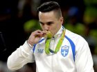 Greece's Eleftherios Petrounias kisses his gold medal for the rings during the artistic gymnastics men's apparatus final at the 2016 Summer Olympics in Rio de Janeiro, Brazil, Monday, Aug. 15, 2016. (AP Photo/Julio Cortez)