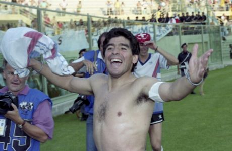 Diego Maradona captain of the Argentinian soccer team widens his arms and celebrates the victory of his team over Yugoslavia in the World Cup quarter final in Florence, Italy, on June 30, 1990. Argentina won in a penalty shoot out after the match ended 0-0 after regular and extra time. (AP Photo/Karl Heinz Kreifelts)