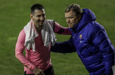 Barcelona's Lionel Messi, left, and Barcelona's head coach Ronald Koeman celebrate after winning a Spanish Copa del Rey round of 16 soccer match against Rayo Vallecano at the Vallecas stadium in Madrid, Spain, Wednesday, Jan. 27, 2021. (AP Photo/Manu Fernandez)