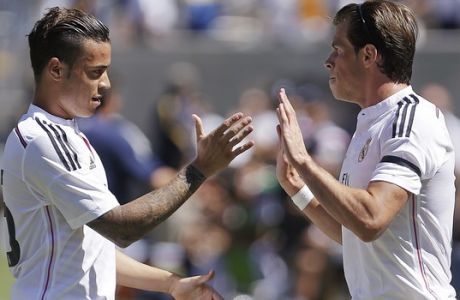 Real Madrid's Gareth Bale, right, celebrates after scoring a goal against Inter Milan with Raul De Tomas during the first half of a soccer match in the first round of the Guinness International Champions Cup, Saturday, July 26, 2014, in Berkeley, Calif. (AP Photo/Ben Margot)