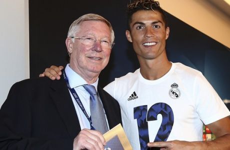 Real Madrid's Cristiano Ronaldo receives his man of the match award from Sir Alex Ferguson after the Champions League final soccer match between Juventus and Real Madrid at the Millennium stadium in Cardiff, Wales Saturday June 3, 2017. (AP Photo/Jan Kruger, UEFA via AP)