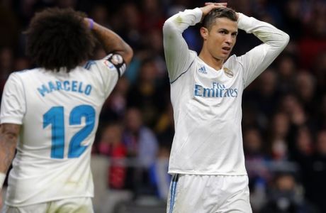 Real Madrid's Cristiano Ronaldo, right and Marcelo react during a Spanish La Liga soccer match between Atletico Madrid and Real Madrid at the Metropolitano stadium in Madrid, Spain, Saturday, Nov. 18, 2017. (AP Photo/Paul White)
