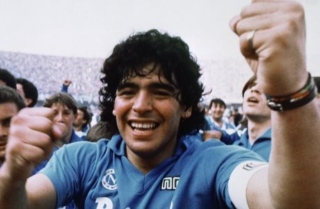 Argentine soccer superstar Diego Armando Maradona cheers after the Napoli team clinches its first Italian major league title in Naples on May 10, 1987. (AP Photo/Meazza Sambucetti)