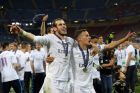 Real Madrid's Gareth Bale and Lucas Vazquez celebrate after the Champions League final soccer match between Real Madrid and Atletico Madrid at the San Siro stadium in Milan, Italy, Saturday, May 28, 2016. Real Madrid won 5-4 on pendata-alties after the match ended 1-1 after extra time.   (AP Photo/Antonio Calanni)