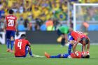 BELO HORIZONTE, BRAZIL - JUNE 28:  Chile players look dejected after being defeated by Brazil in a penalty shootout during the 2014 FIFA World Cup Brazil round of 16 match between Brazil and Chile at Estadio Mineirao on June 28, 2014 in Belo Horizonte, Brazil.  (Photo by Buda Mendes/Getty Images)