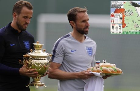 England head coach Gareth Southgate, holds a loaf of bread and England's Harry Kane holds a Russian tea urn they received during a traditional Russian greeting before the start of the first training session for the England team at the 2018 soccer World Cup at the Spartak Zelenogorsk stadium, Zelenogorsk near St. Petersburg, Russia, Wednesday, June 13, 2018. (AP Photo/Alastair Grant)