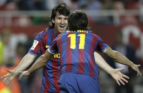 Barcelona's Bojan Krkic, front, celebrates with teammate Lionel Messi from Argentina, behind, after scoring against Sevilla  during their La Liga soccer match at the Ramon Sanchez Pizjuan stadium on Saturday, May 8, 2010. (AP Photo/Angel Fernandez)