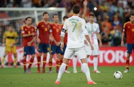 Portuguese forward Cristiano Ronaldo concentrates before a free kick during the Euro 2012 football championships semi-final match Portugal vs Spain on June 27, 2012 at the Donbass Arena in Donetsk. AFP PHOTO / JEFF PACHOUD        (Photo credit should read JEFF PACHOUD/AFP/GettyImages)