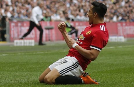Manchester United's Alexis Sanchez celebrates after scoring his sides 1st goal, as Manchester United's manager Jose Mourinho runs to the touchline to celebrate in the background, during the English FA Cup semifinal soccer match between Manchester United and Tottenham Hotspur at Wembley stadium in London, Saturday, April 21, 2018. (AP Photo/Frank Augstein)
