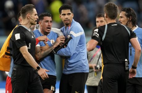 Uruguay's Jose Gimenez argues with the referee at the end of a World Cup group H soccer match against Ghana at the Al Janoub Stadium in Al Wakrah, Qatar, Friday, Dec. 2, 2022. (AP Photo/Darko Vojinovic)