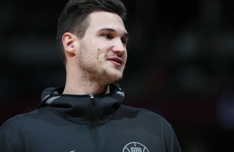Los Angeles Clippers forward Danilo Gallinari smiles as he is honored, during a timeout, for his years as a member of the Denver Nuggets, in his first return to the arena since signing with the Clippers, at an NBA basketball game Tuesday, Feb. 27, 2018, in Denver. (AP Photo/David Zalubowski)